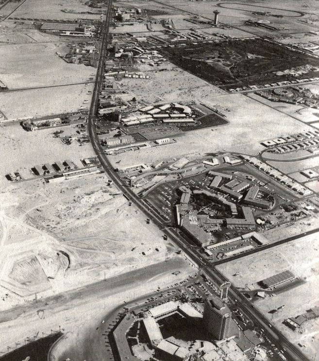 Sands hotel tower can be seen under construction in the upper middle part of the photo. Lower left, the beginnings of caesars palace. On the far lower right, three coin motel and galaxy motel. _1965